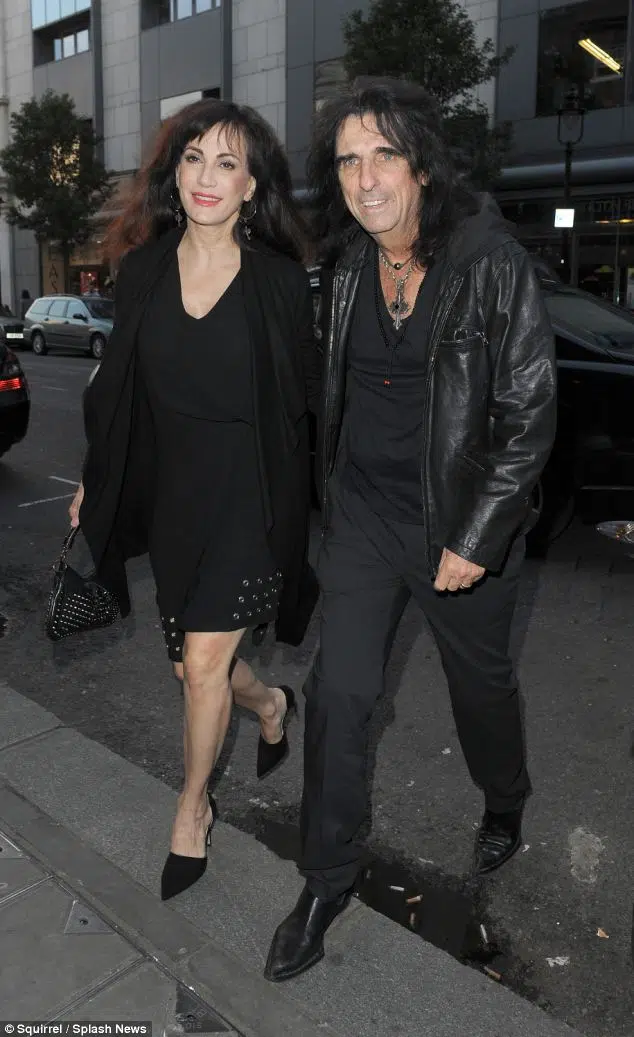 That's sweet: Rocker Alice Cooper let's his wife wear the eyeliner as they enjoy a dinner date in London