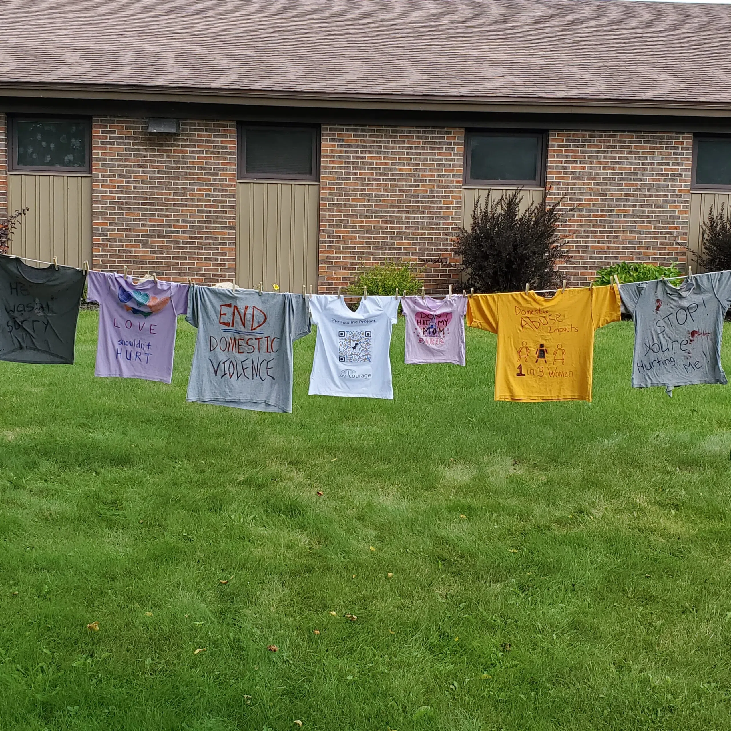 InCourage Hanging Clothes to Honor Domestic Violence Awareness Month