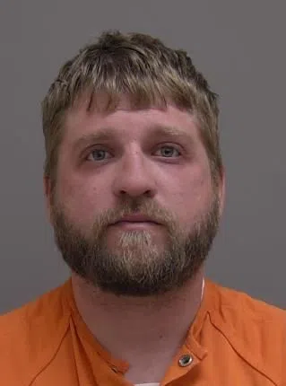 Charges Official for Man Held at Gunpoint