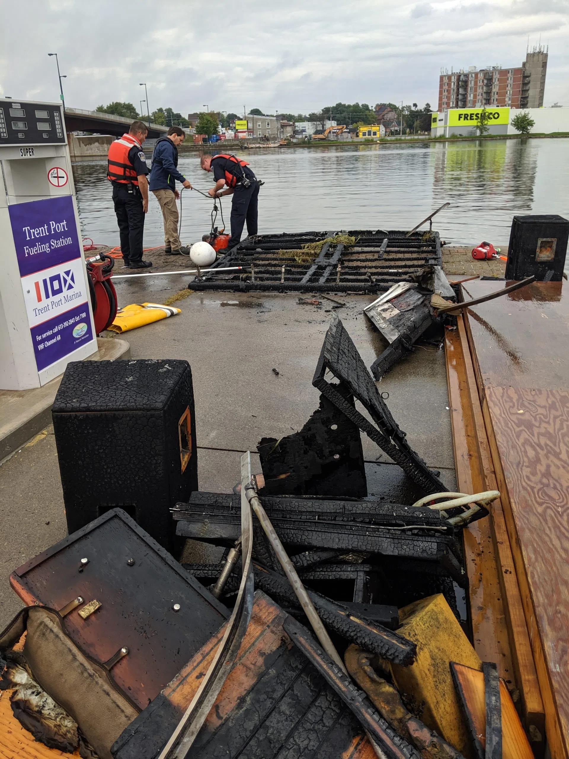 Burned boat lifted out of water