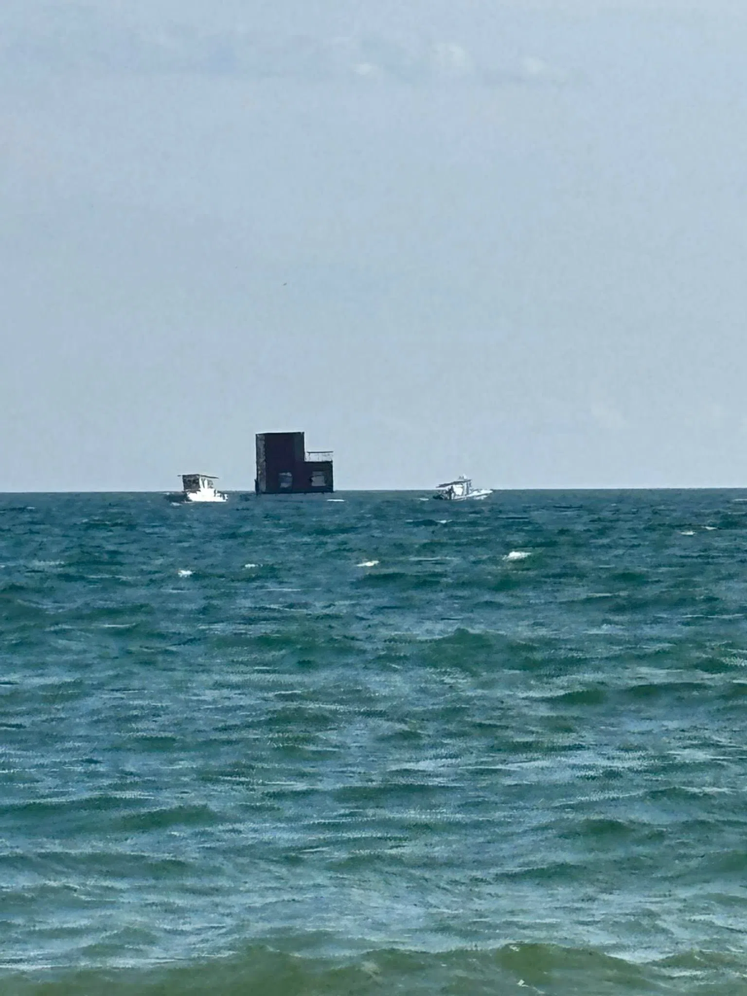 Brighton Marine Rescue tows house on barge safely to shore