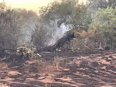 House fire triggers massive grass fire, threatens others