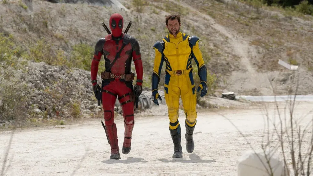 Deadpool and Wolverine walking down a dirt path