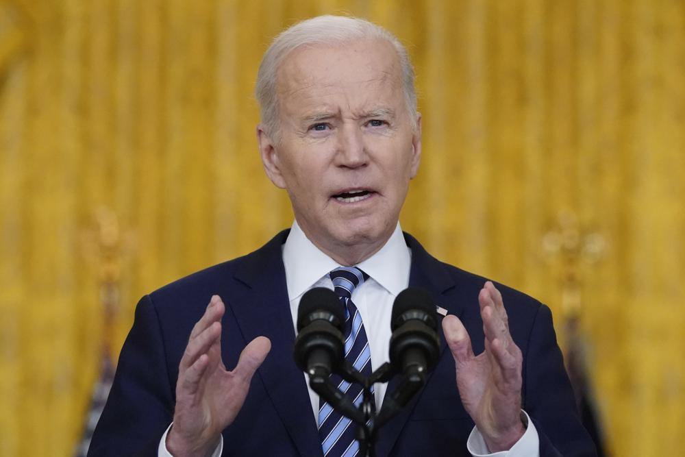 Biden hits Russia with sanctions, shifts troops to Germany