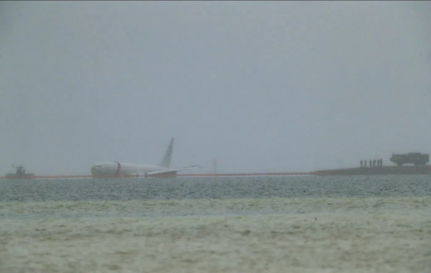 Navy plane overshoots runway and ends up in ocean, but all 9 aboard escape unharmed