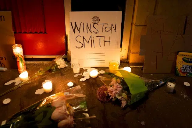 Candles and flowers are arranged at a vigil for Winston Boogie Smith Jr.