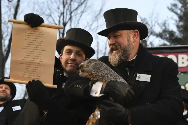 Groundhog Club handler A.J. Dereume holds Punxsutawney Phil, the weather prognosticating groundhog, while Vice President Dan McGinley reads the scroll during the 137th celebration of Groundhog Day on Gobbler's Knob in Punxsutawney, Pa., Thursday, Feb. 2, 2023. Phil's handlers said that the groundhog has forecast six more weeks of winter.