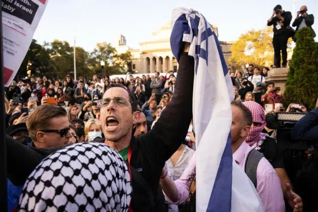FILE - A pro-Israel demonstrator shouts at Palestinian supporters during a protest at Columbia University, Thursday, Oct. 12, 2023, in New York. As the death toll rises in the Israel-Hamas war, American colleges have become seats of anguish with many Jewish students calling for strong condemnation after civilian attacks by Hamas while some Muslim students are pressing for recognition of decades of suffering by Palestinians in Gaza.
