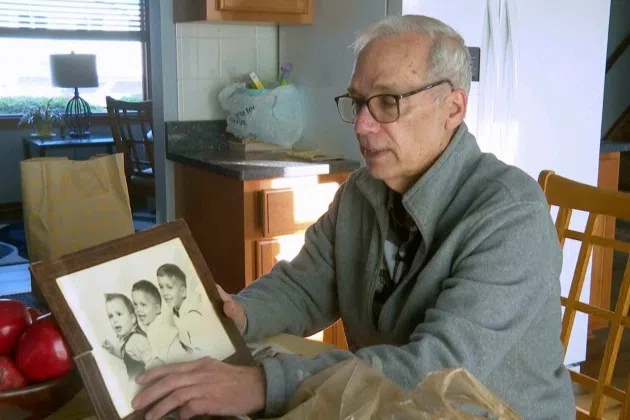 John Prevost points to an old photo of his brothers, including the newly elected Pope Leo XIV, Robert Prevost, left, during an interview with the Associated Press on Thursday, May 8, 2025, in New Lennox, Ill.