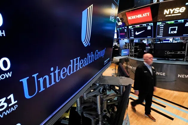 FILE - The logo for UnitedHealth Group appears above a trading post on the floor of the New York Stock Exchange, April 17, 2025.