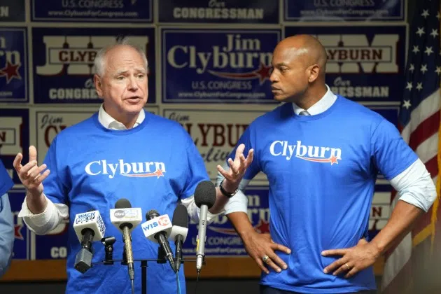 FILE - Minnesota Gov. Tim Walz, left, speaks to reporters as Maryland Gov. Wes Moore looks on at Rep. Jim Clyburn's World Famous Fish, Friday, May 30, 2025, in Columbia, S.C.
