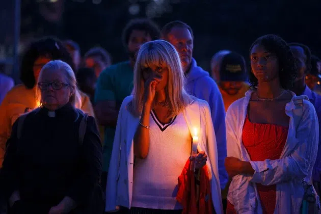 People gather at a vigil at Lynnhurst Park after a shooting at the Annunciation Catholic School Wednesday, Aug. 27, 2025, in Minneapolis.
