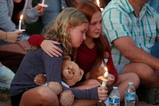 People gather at a vigil at Lynnhurst Park after a shooting at the Annunciation Catholic School, Wednesday, Aug. 27, 2025, in Minneapolis.