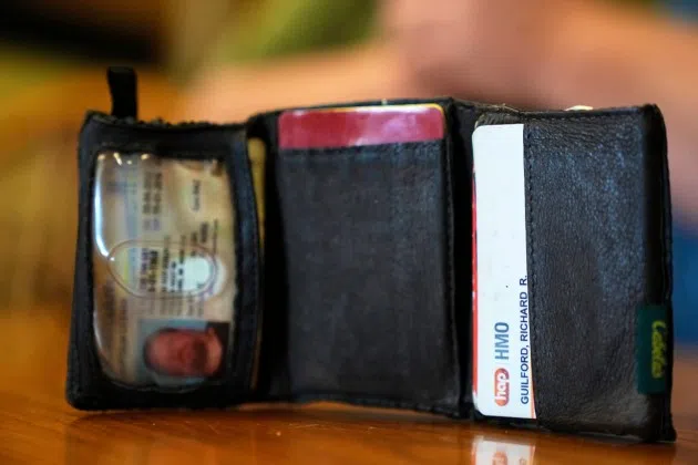 The old wallet of Richard Guilford is seen as he speaks during an interview Thursday, Aug. 14, 2025, in Petersburg, Mich.