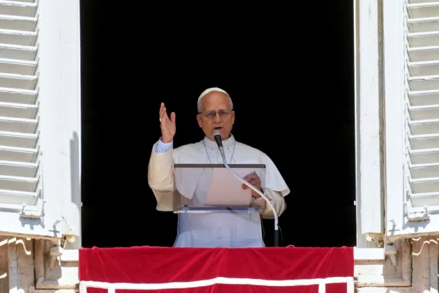 Pope Leo XIV delivers his blessing as he recites the Angelus noon prayer from the window of his studio overlooking St.Peter's Square, at the Vatican, Sunday, Aug. 31, 2025