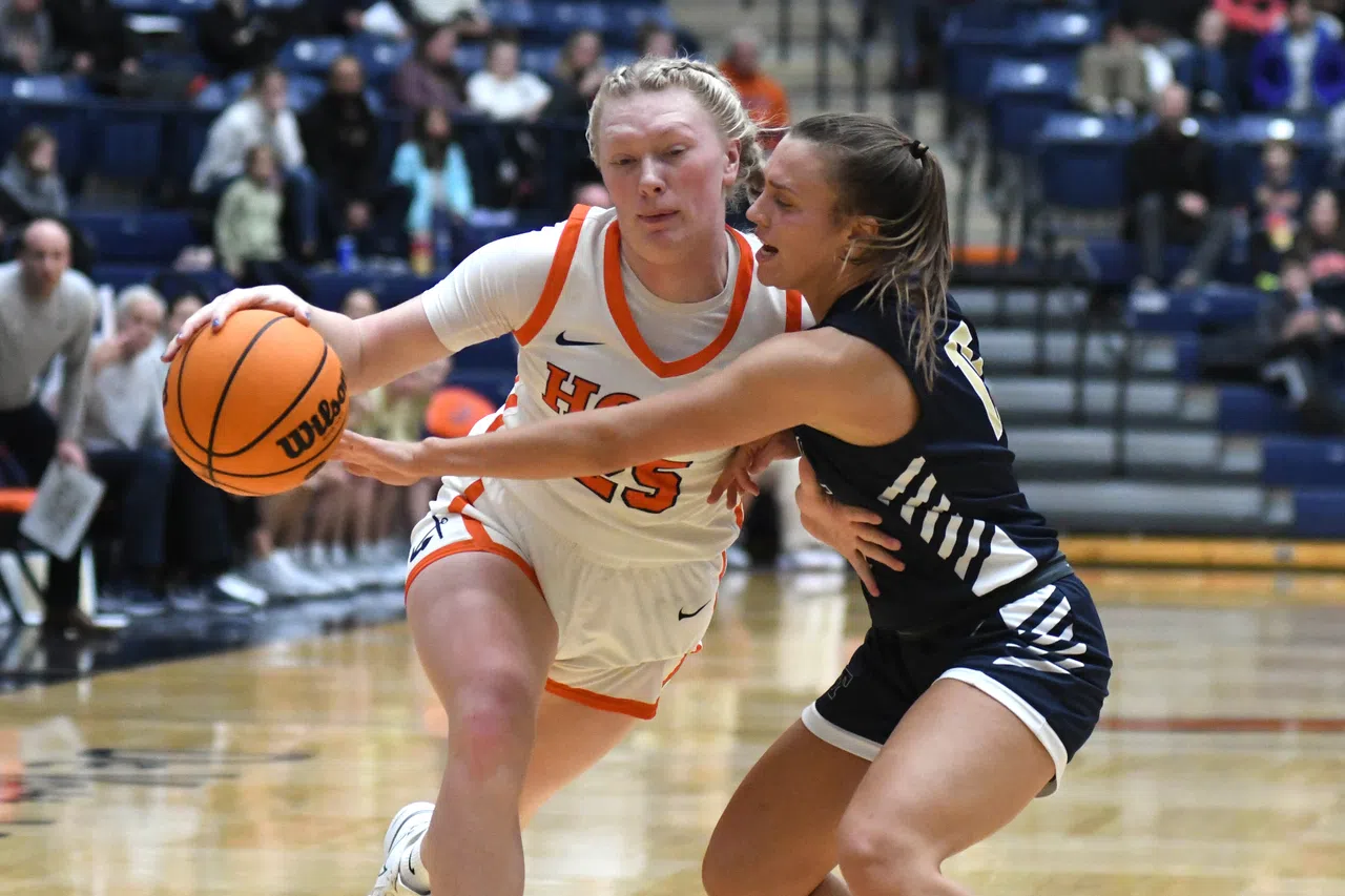 Hope College's Sydney Vis dribbles past a Trine defender