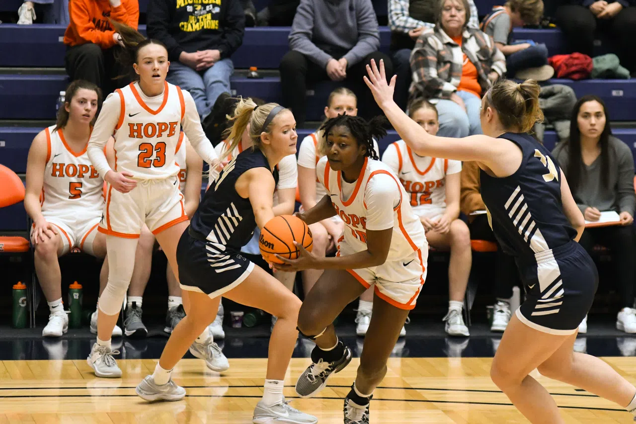 Hope College's Raven Jemison drives between two Trine University defenders.
