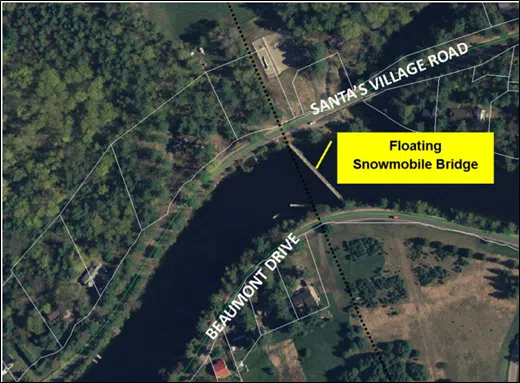 Annual installation of the floating snowmobile bridge