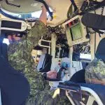 A CAF member in a tactical armoured patrol vehicle