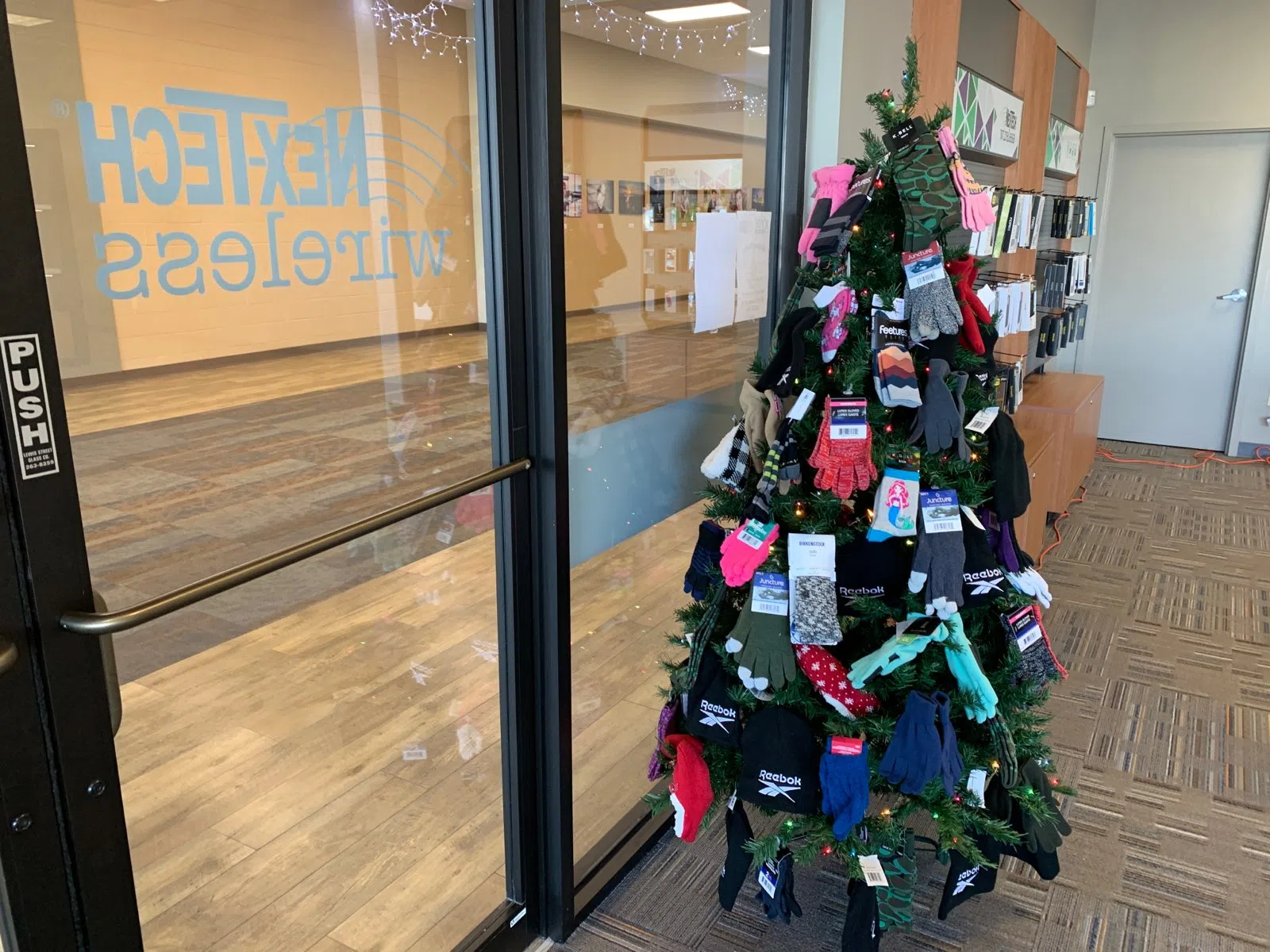 Brown's Shoe Fit donates items to KVOE Mitten Tree located at Flinthills Mall after recent theft