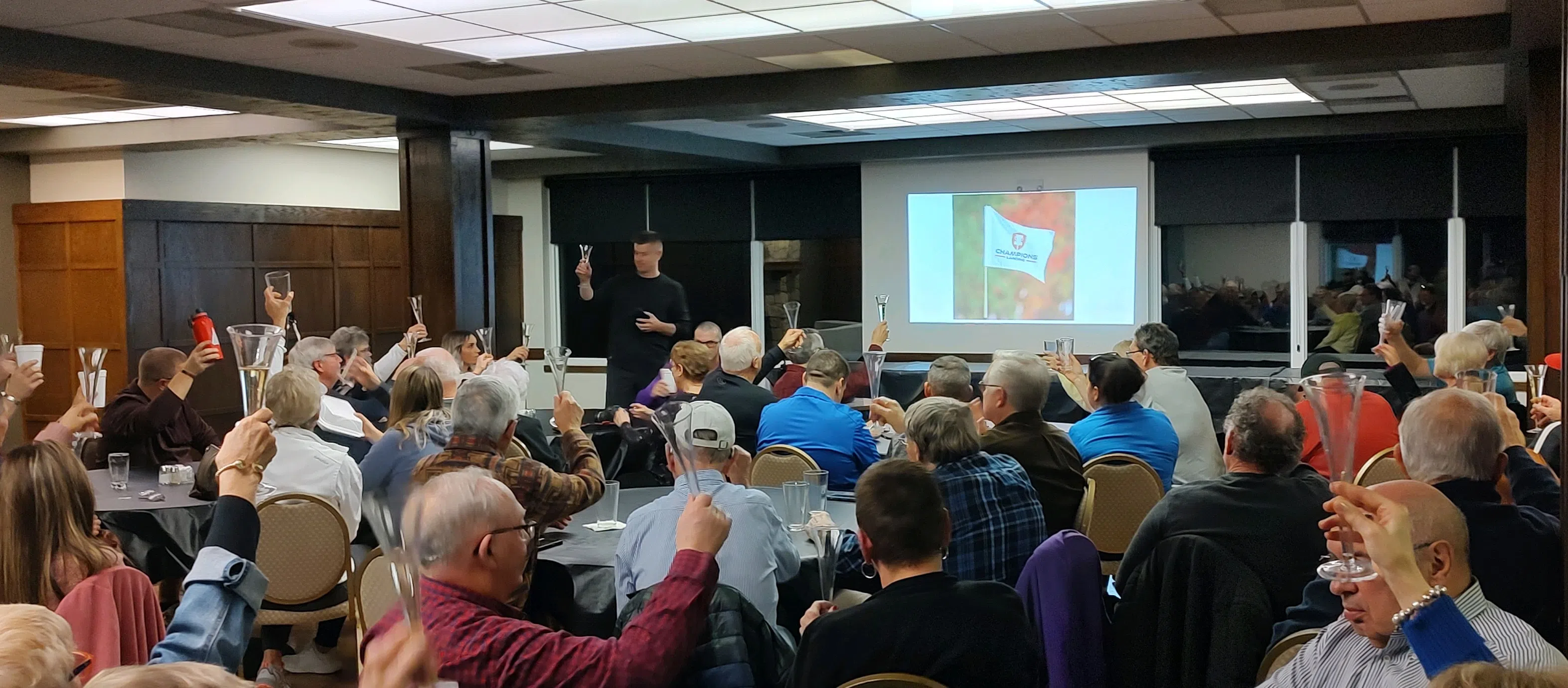 Community members toast to the future of newly named 'Champion's Landing' and new owner Jeremy Rusco Thursday night