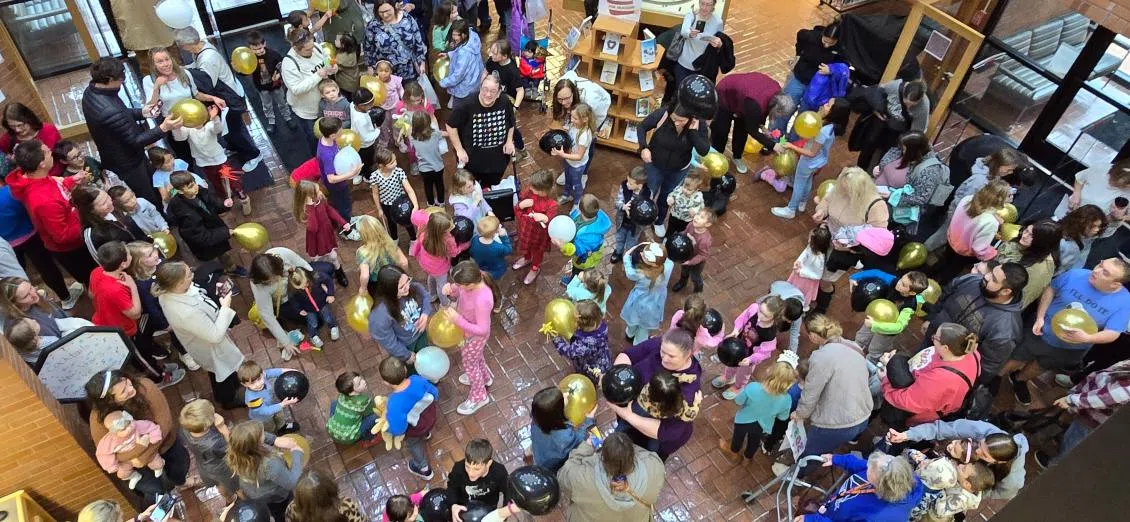 Residents of all ages ring in the Noon-Year inside of Emporia Public Library on New-Year's Eve