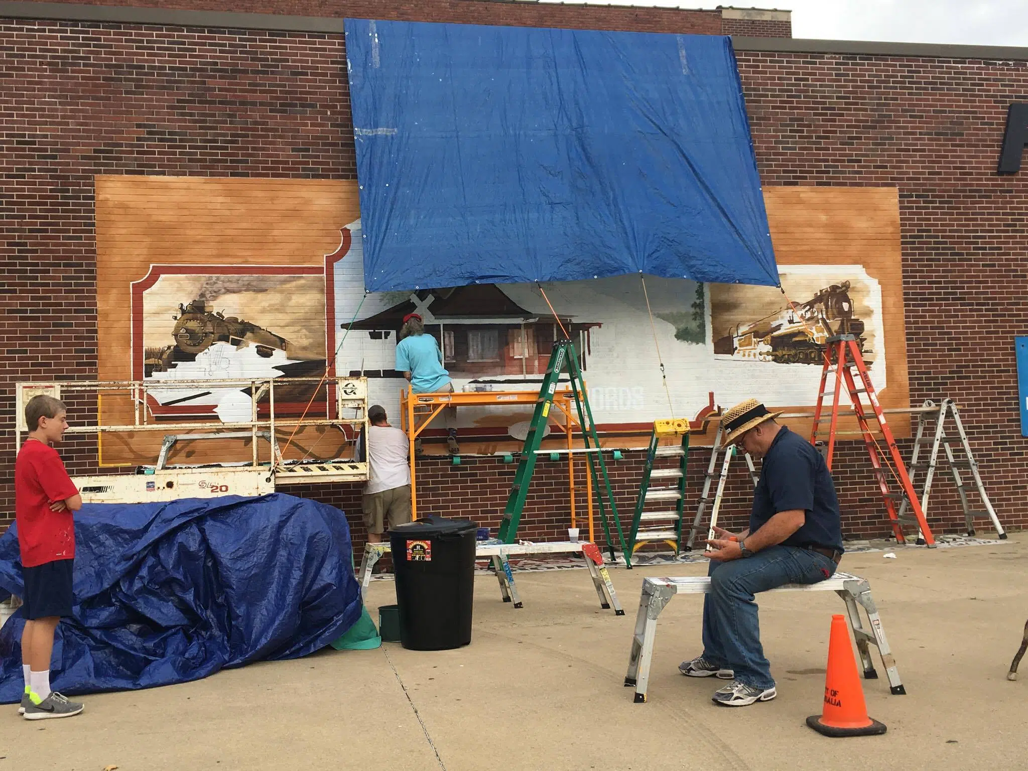 Downtown Mural work continues with "Little Toot" giving rides to Children
