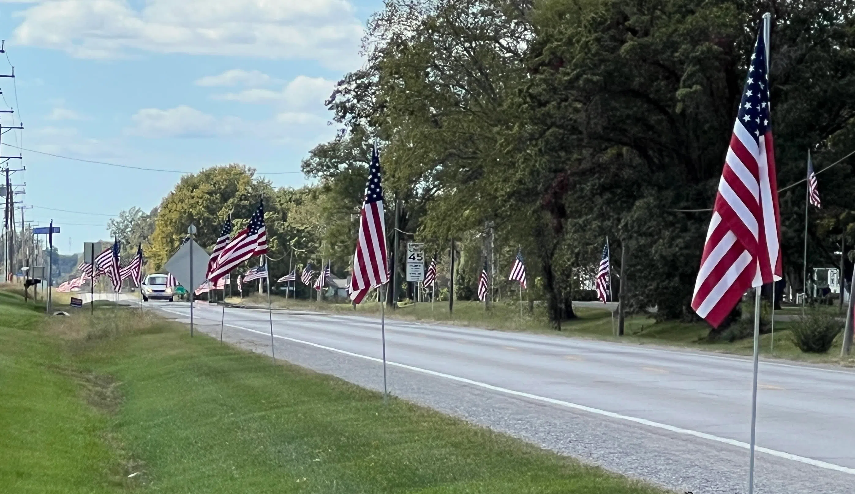 Flags lining U.S. Route 40 in Brownstown for service for SGT Bradley Clinton Schwarm