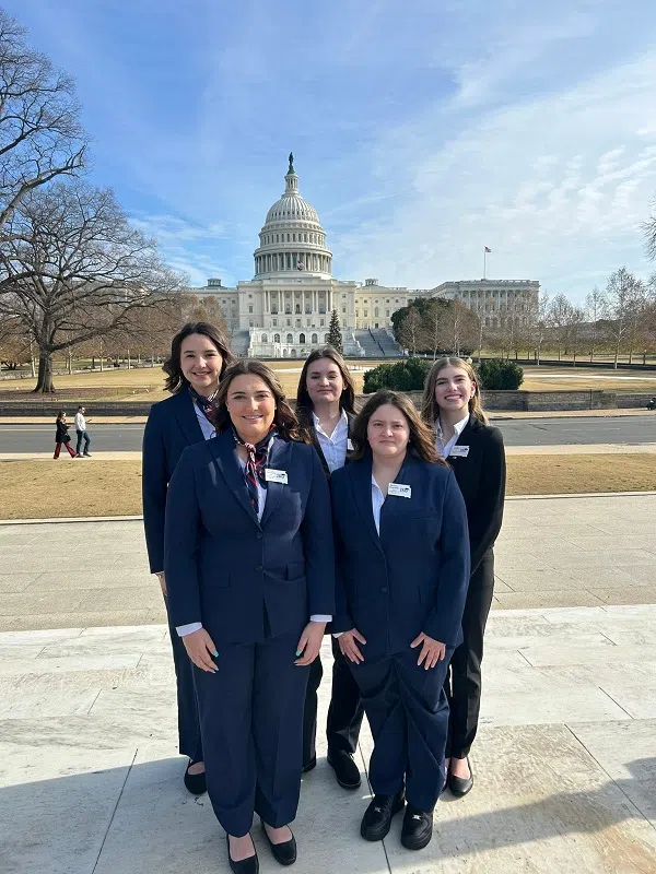 JAG South Dakota state officers pose for a photo in Washington, D.C., with the U.S. Capitol Building in the background.