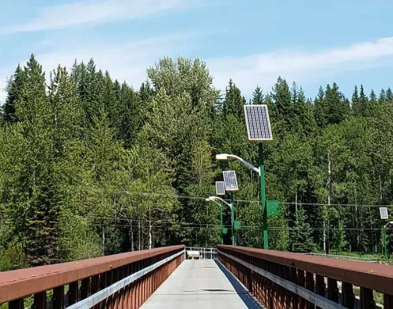 Distcit of Sparwood replacing solar batteries on Elk River Pedestrian Bridge