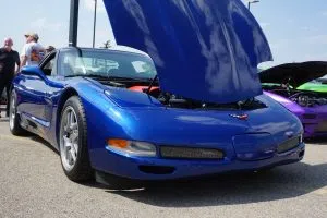 A striking C5 blue Corvette is showcased at a Calgary car show, highlighting its sleek design and vibrant color.