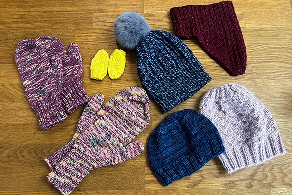 Donations From Yarn Twisters customers for the Women’s Centre Of Calgary, it includes toques, gloves, beanies and cowls