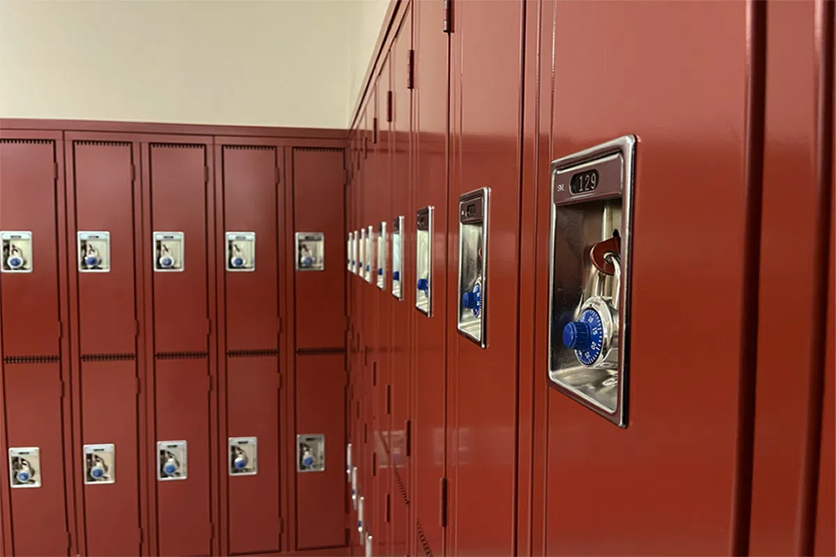 Close up on red, half size lockers with silver and blue combination lockc