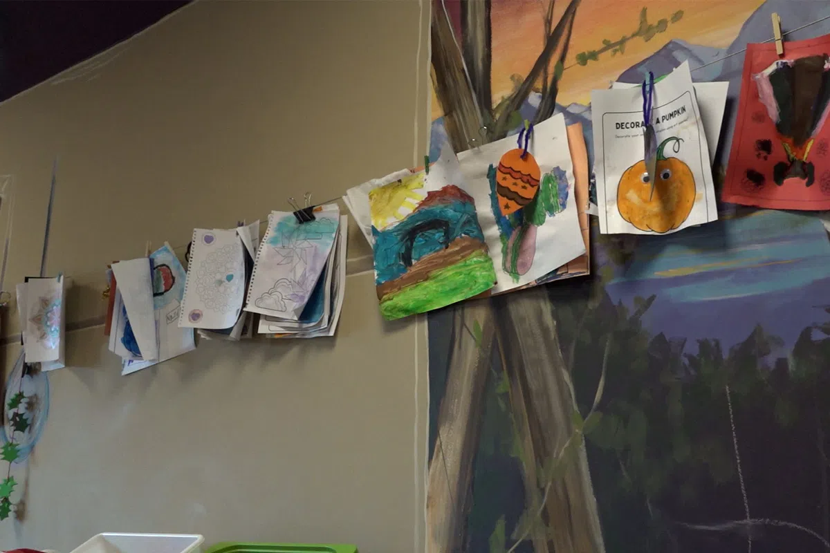 A clothesline in the arts and crafts room at the Children's Cottage Society showcases colourful art made by kids in the Crisis Nursery