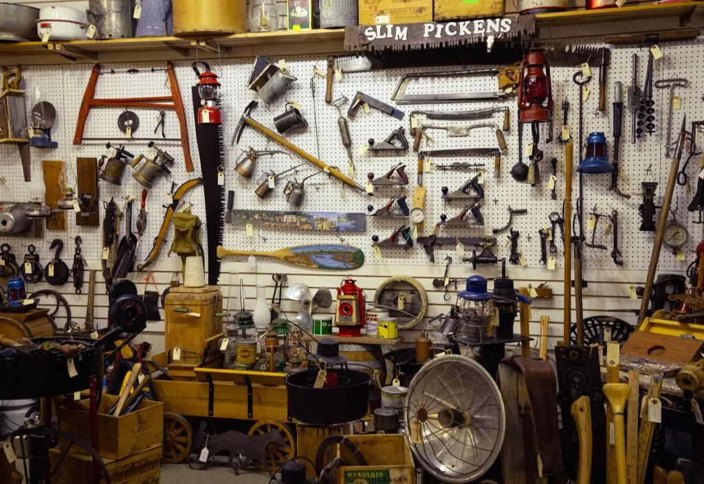 An entire wall of tools and outdoor equipment that have been mounted on the wall.