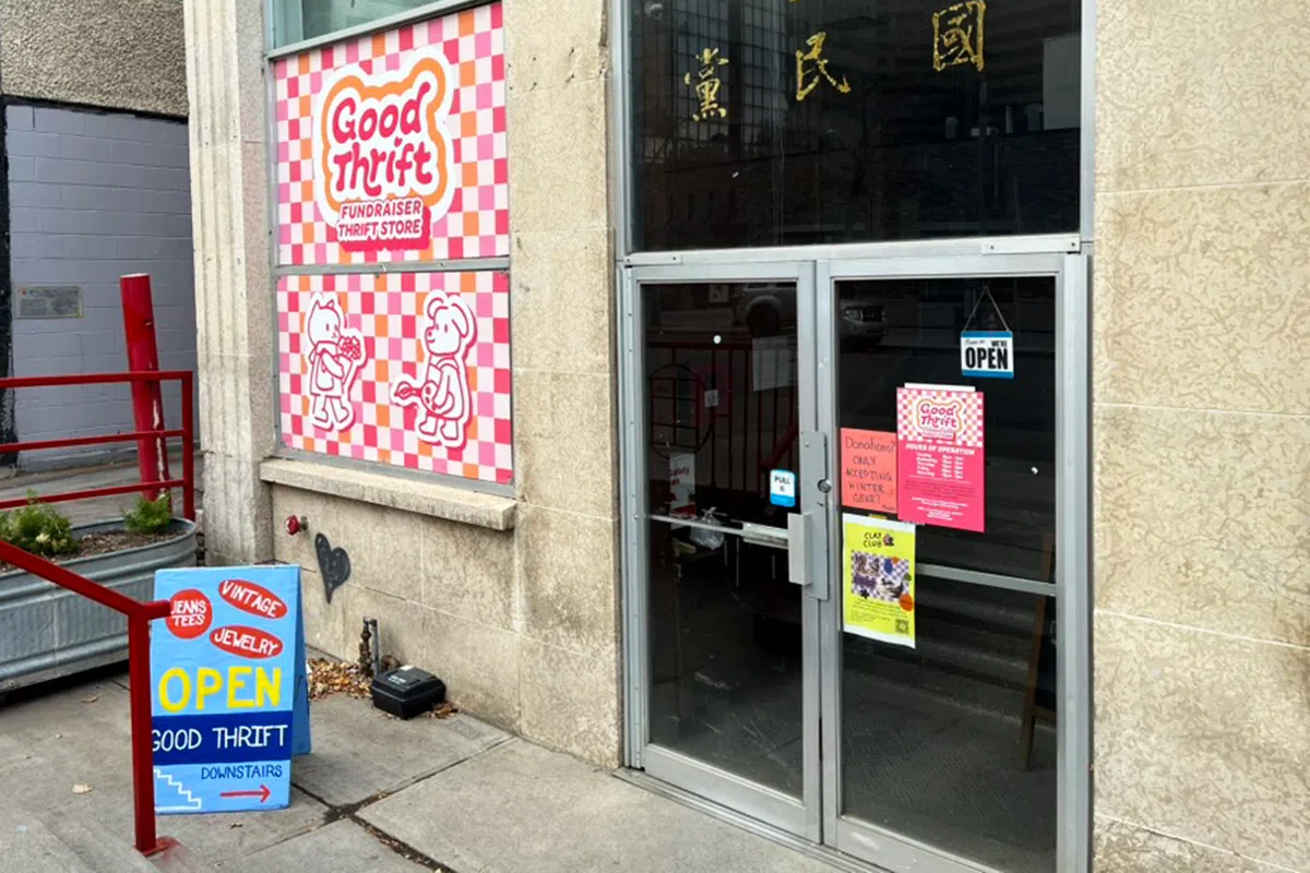 The exterior of the fundraising store Good Thrift has a colourful window decoration. The storefront is located in Chinatown.