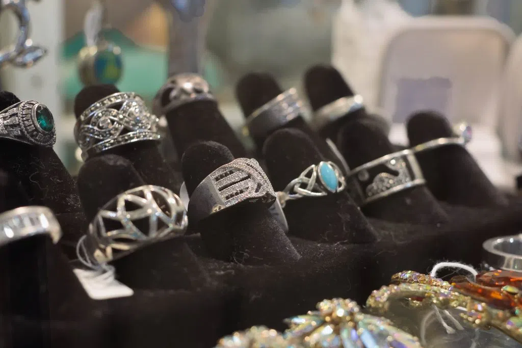A black velvet display filled with antique silver rings.