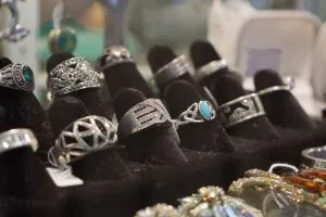 A black velvet display filled with antique silver rings.