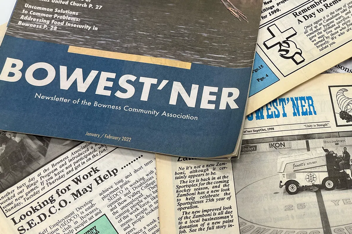 Several covers of The Bowest'ner newsletter are spread out on a table, overlapping each other.