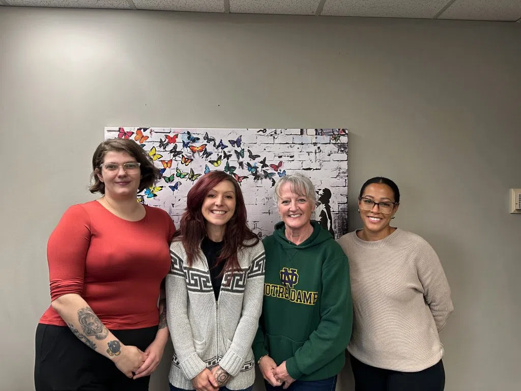 A group of birthmothers smiling together at an Adoption Options event, representing their stories and journeys with adoption.