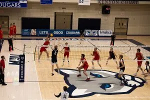 Dinos outside hitter No. 24 Will Kay smashes home a second set winning kill past Cougars No. 2 Kale Orr.