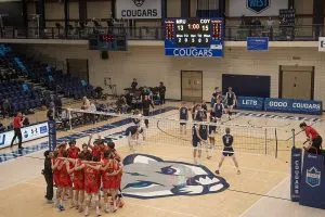 The Dinos Men's Volleyball players huddle up and dance after their come from behind victory against the MRU Cougars, ending the Cougars season.