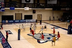 Cougars Middle #7 Mattias Dirks rises up to block the kill from Dinos #22 Sam Kay to set up match point in the third set.