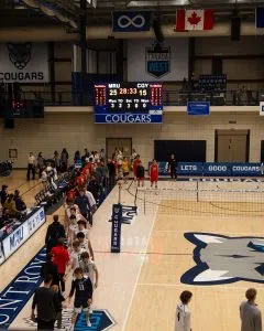 MRU Cougars and U of C Dinos players shake hands after their hard fought game.