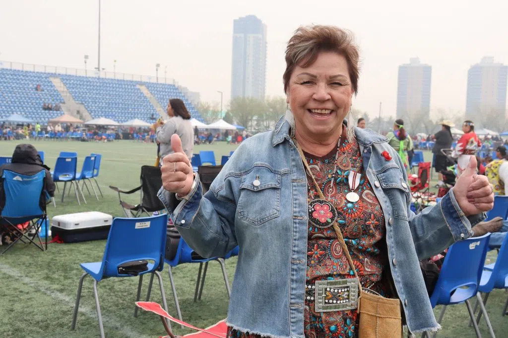 Elizabeth Betty Letendra, Organizer of the Ben Calf Robe Traditional Pow Wow giving the thumbs up at the 40th annual Pow Wow (Photo Credits – Daniel Barker-Tremblay)