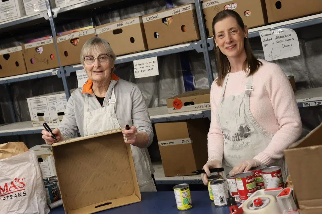 St. Albert Food Bank volunteers making a food hamper (Photo Credits – Daniel Barker-Tremblay)