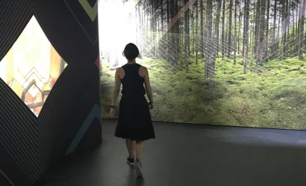 A women walking through the UNCEDED: Voices of the Land exhibit (Photo Credits – Daniel Barker-Tremblay)