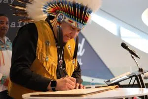 Peerless Trout First Nation Chief Gilbert Okemow signing the deal with Tamarack Valley Energy (Photo Credits – Daniel Barker-Tremblay)