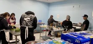 Siksika youth learning culinary arts at the 2025 Artsdance, photo by William L Baliko