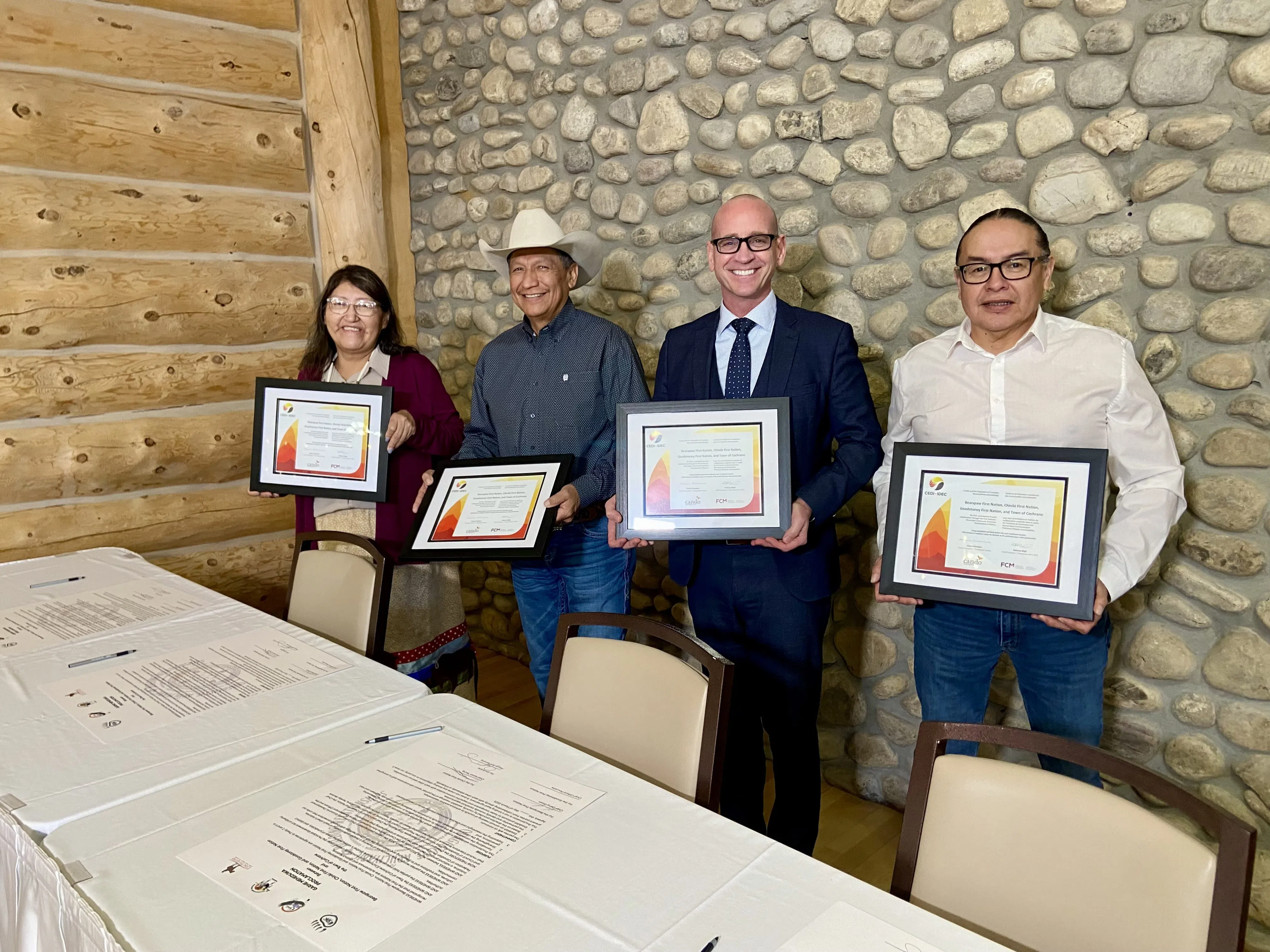 Chief Darcy Dixon, Chief Aaron Young, Chief Clifford Pouchette, and Mayor Jeff Genung at the signing table, photo by William L Baliko